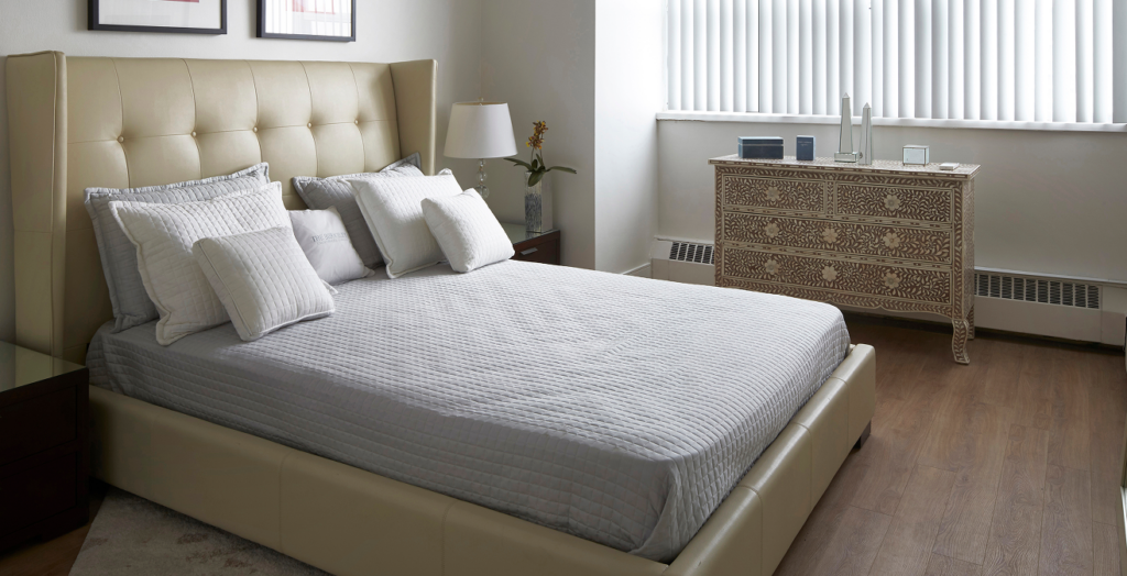 Large master bedroom at 18 Brownlow with premium acoustic flooring and expansive windows in a high-end Midtown Toronto rental.